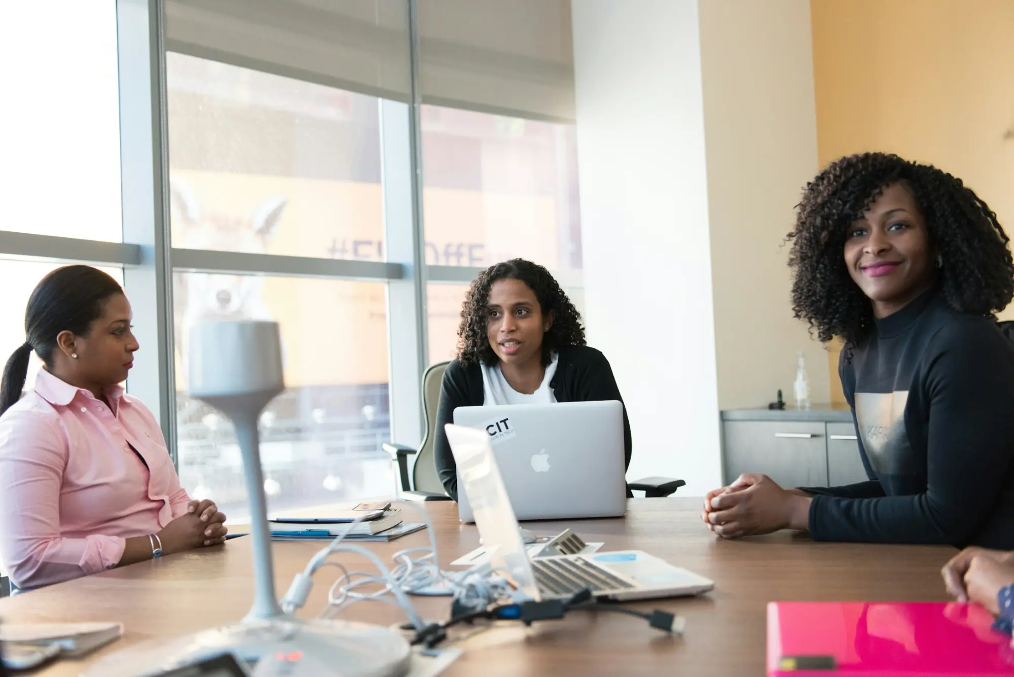 A team meeting in a bright, glass-walled boardroom