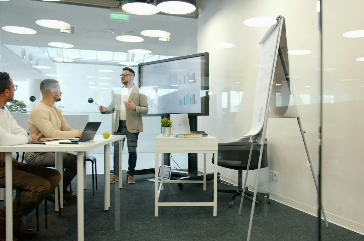 A presenter leading a meeting in a bright office