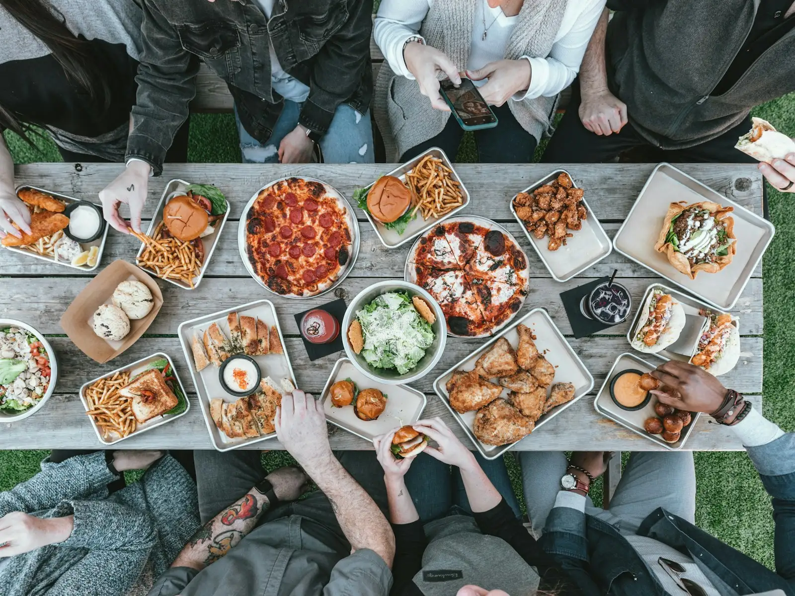 Colleagues sharing a table full of food