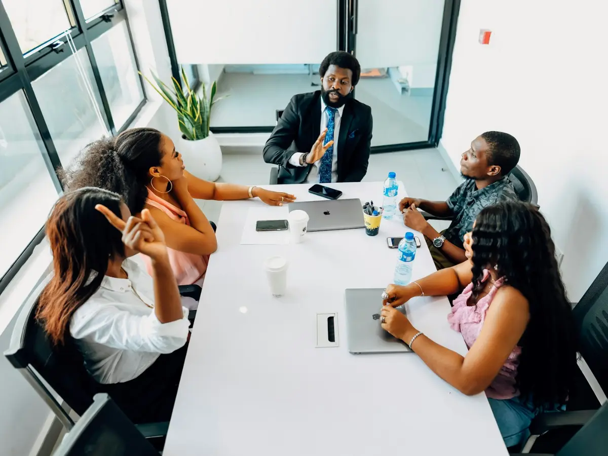 A leader listening to colleagues around a table
