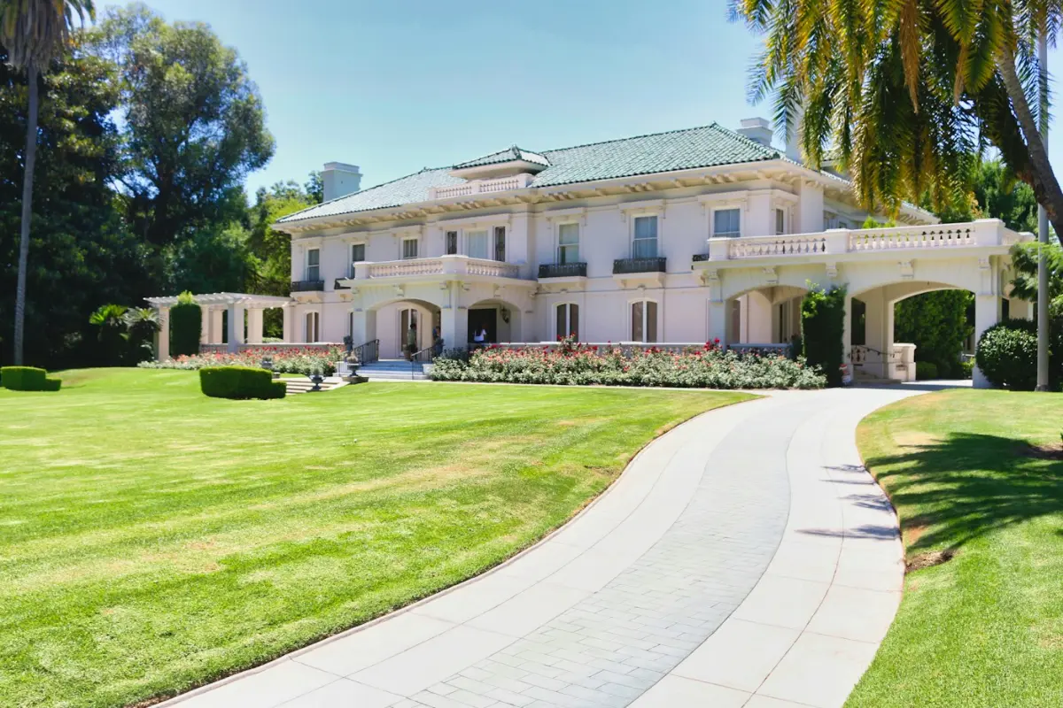 A classic estate home with a sweeping driveway, illustrative