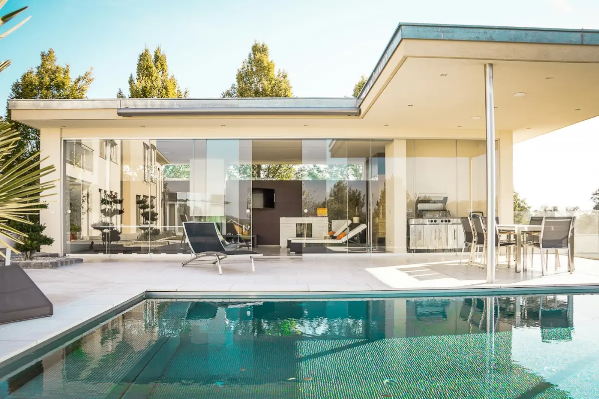 A modern villa opening onto a swimming pool, illustrative