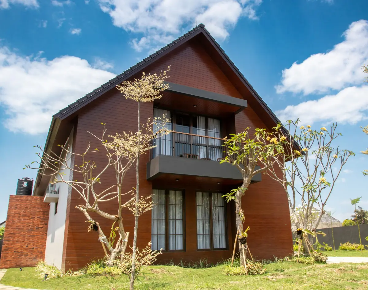 A contemporary brick house under a blue sky, illustrative